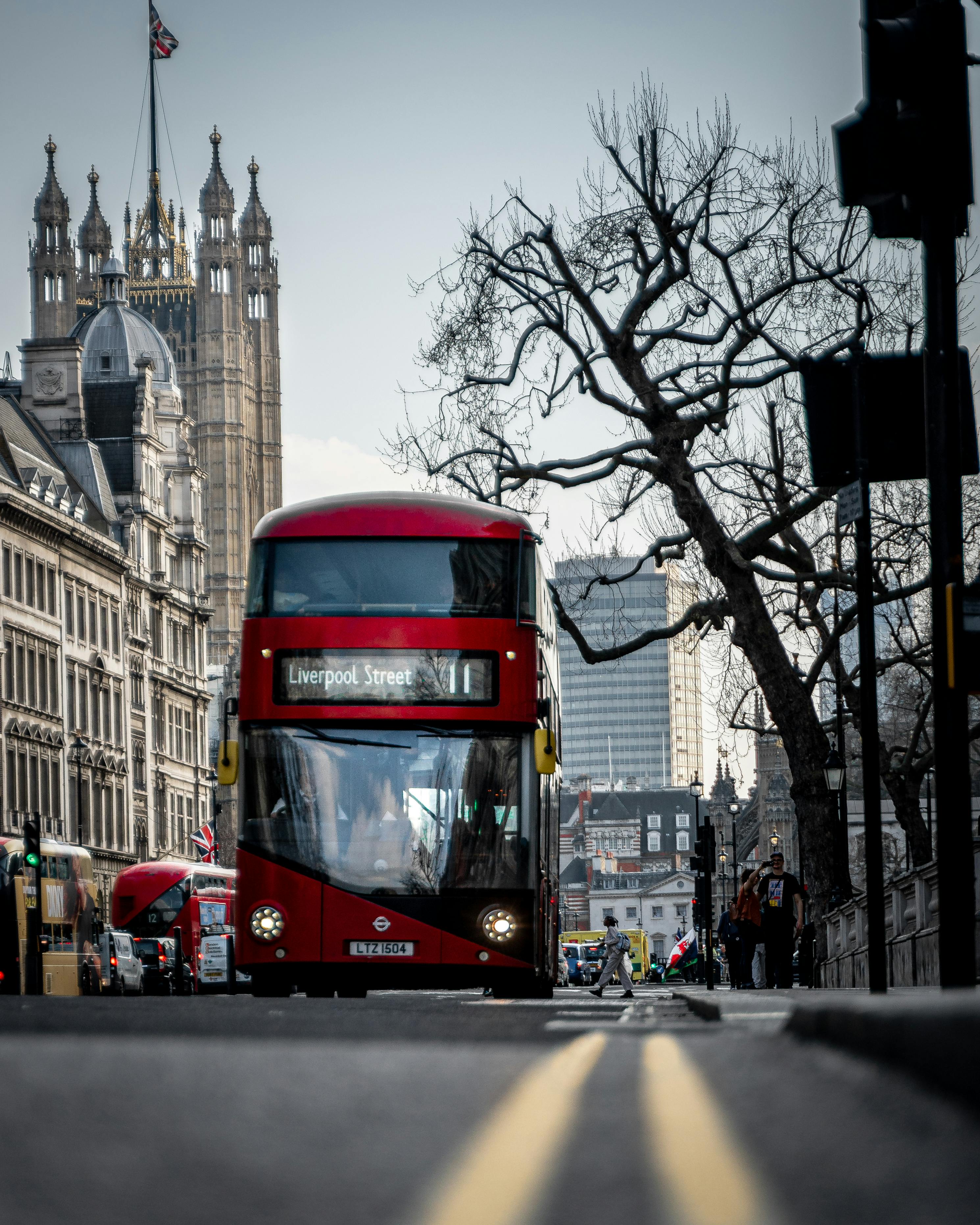 Iconic London red bus near the Houses of Parliament, representing the UK arts and culture scene